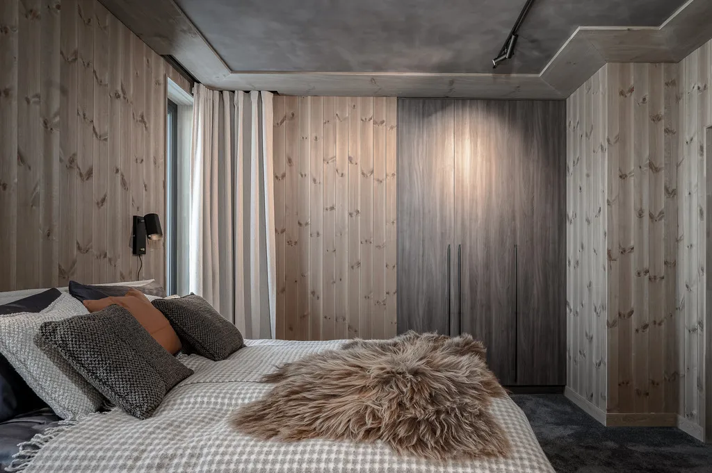 Apartment A11, Kvitfjell, Norway: double bedroom with timber walls and fitted wardrobes