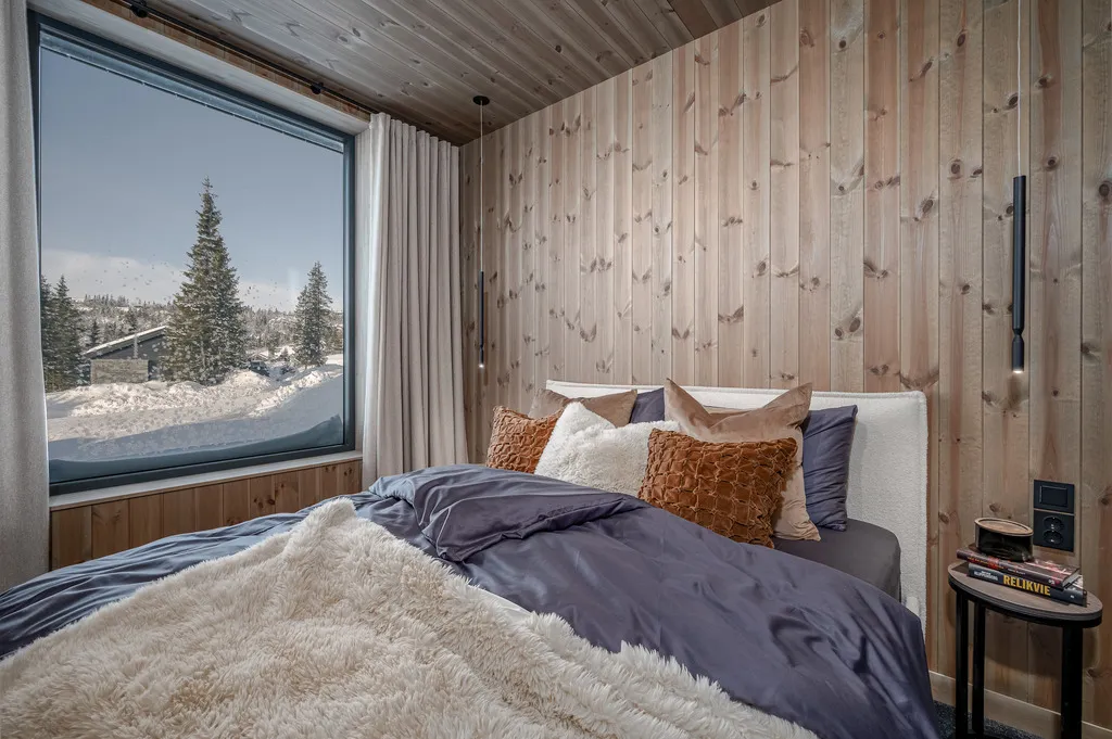 Apartment A11, Kvitfjell, Norway: timber-lined double bedroom overlooking snow-covered trees