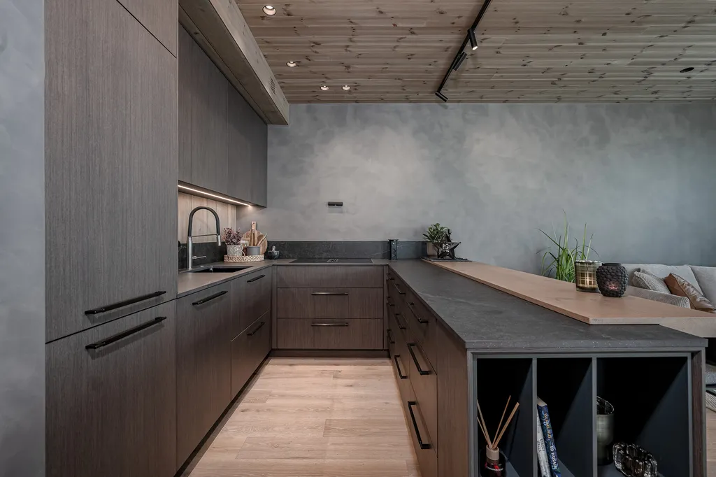 Apartment A11, Kvitfjell, Norway: kitchen cabinetry and worktops beneath a timber ceiling