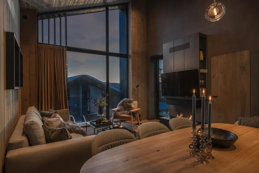 Apartment B22, Kvitfjell, Norway: living and dining area with a fireplace and slope-facing windows
